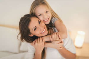 mother and daughter receive family and cosmetic dentistry