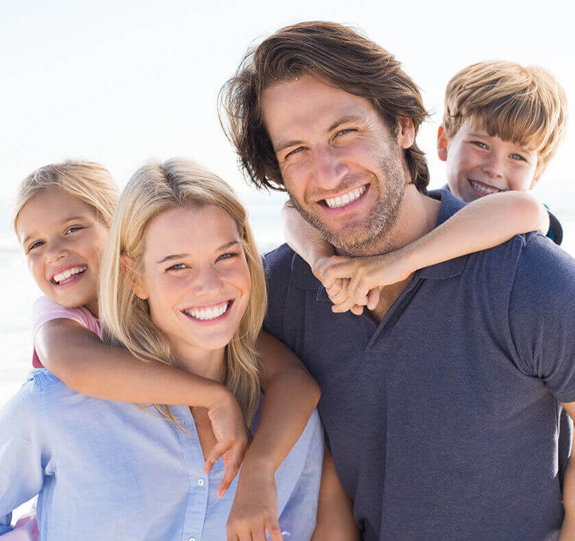 smiling family receive restorative dentistry together