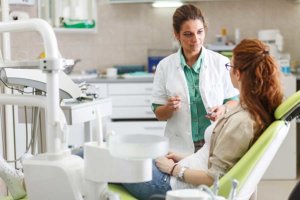Hygienist talking to patient about advanced dental care