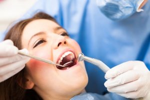 Young women getting dental exam knows how to prevent gum diseases