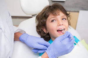 Kid in dentist chair during National children's Dental Health Month